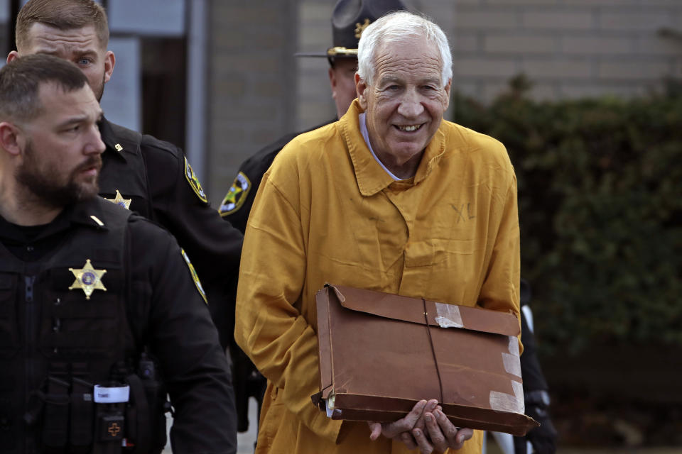 Former Penn State University assistant football coach Jerry Sandusky, center, leaves the Centre County Courthouse after attending a resentencing hearing on his 45-count child sexual abuse conviction Friday, Nov. 22, 2019. (AP Photo/Gene J. Puskar)