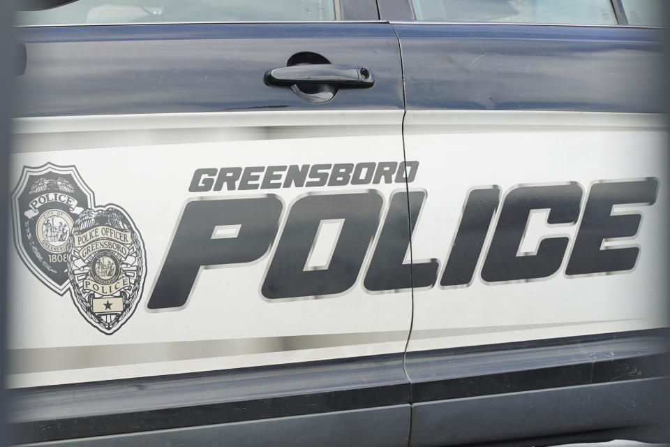 A cruiser sits in a parking lot outside police headquarters in Greensboro, N.C., on Wednesday, June 22, 2022. The city decided to let lapse its contract with Fog Reveal, a powerful phone-tracking tool that some advocates fear violates people's privacy rights. (AP Photo/Allen G. Breed)