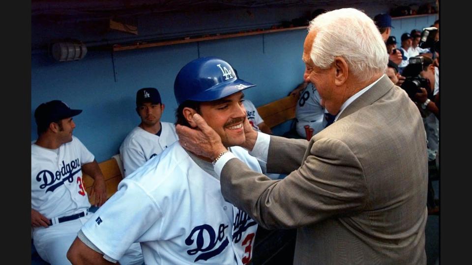 Tommy Lasorda shares a tender moment with catcher Mike Piazza before the Dodgers retired Lasorda's jersey on Aug. 15, 1997.