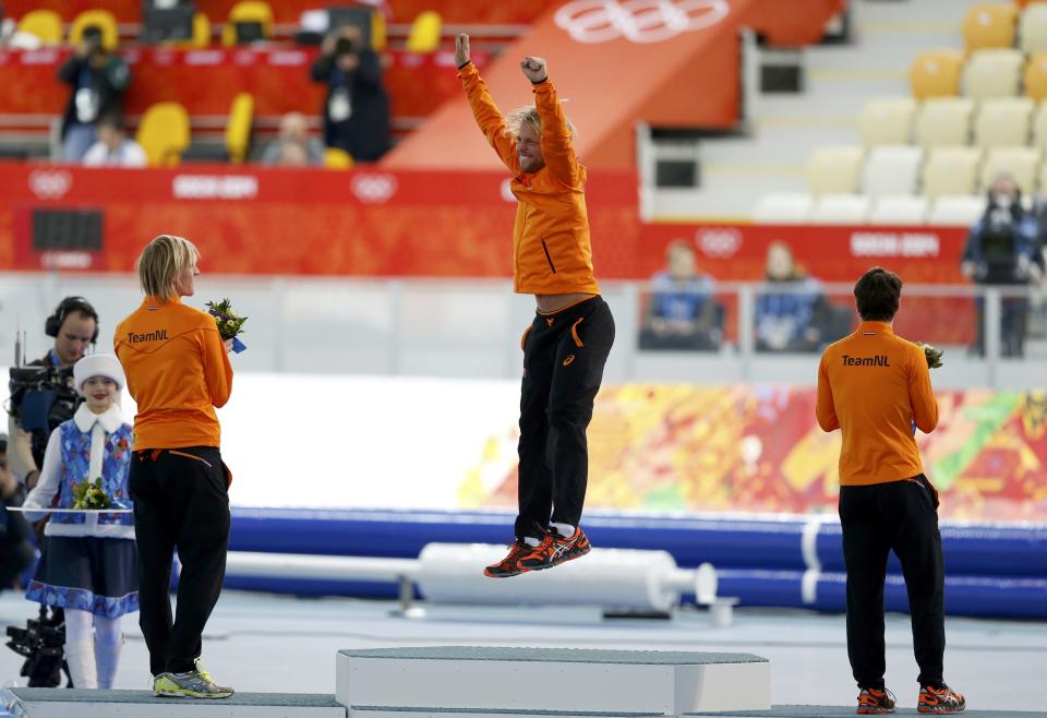 Winner of the men's 500 meters speed skating competition Michel Mulder of the Netherlands celebrates at the flower ceremony for the event at the 2014 Sochi Winter Olympics, February 10, 2014. REUTERS/Issei Kato (RUSSIA - Tags: OLYMPICS SPORT SPEED SKATING)