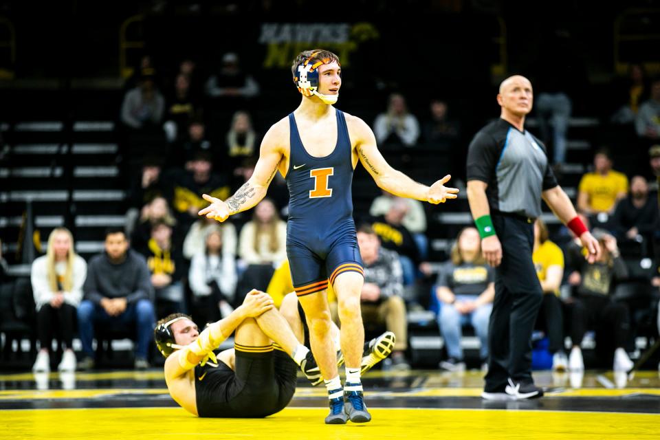 Illinois' Lucas Byrd, right, reacts after pinning Iowa's Cullan Schriever at 133 pounds during a NCAA Big Ten Conference men's wrestling dual, Friday, Jan. 6, 2023, at Carver-Hawkeye Arena in Iowa City, Iowa.