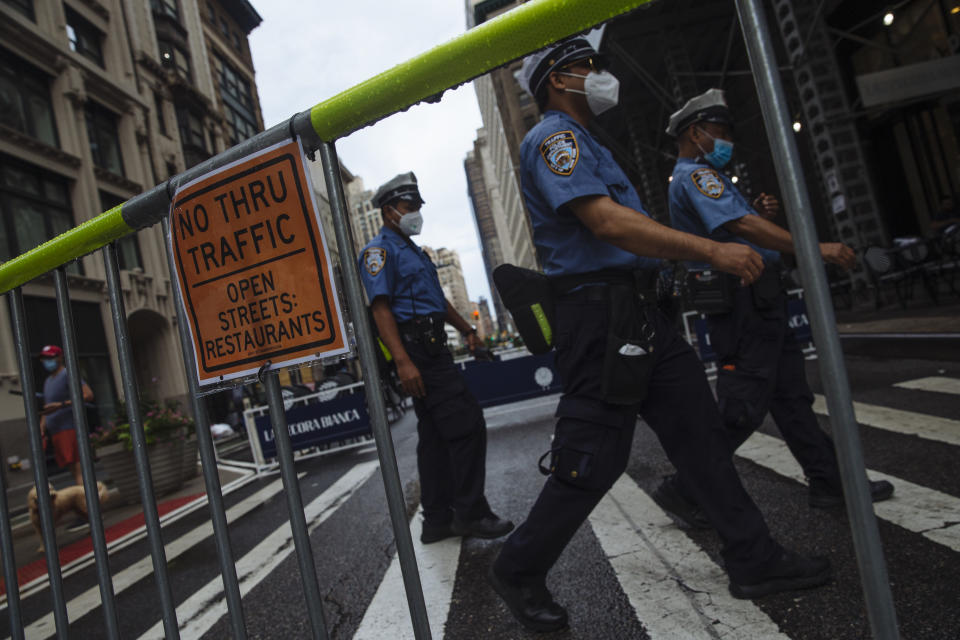 New York Police Department officers walk on a closed section of Broadway in the Flatiron neighborhood of New York, U.S., on Monday, July 6, 2020. (Angus Mordant/Bloomberg via Getty Images)