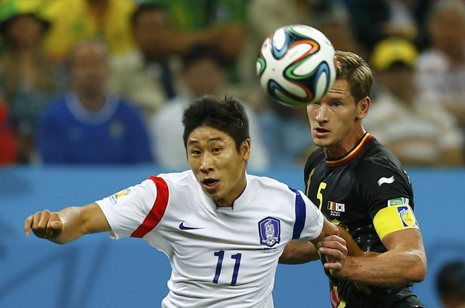 South Korea's Lee Keun-ho fights for the ball with Belgium's Jan Vertonghen during their 2014 World Cup Group H soccer match at the Corinthians arena