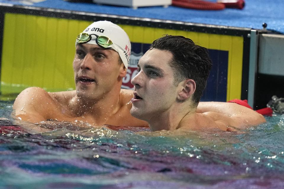 Ryan Held, left, and Jack Alexy, right, look at the final times after the 50-meter freestyle at the U.S. national championships swimming meet, Saturday, July 1, 2023, in Indianapolis. Held won the event. (AP Photo/Darron Cummings)