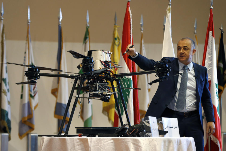 Lebanese Defense Minister Elias Bou Saab points to parts of an Israeli drone that crashed in southern Beirut last month during a press conference to announce the results of an investigation into the incident, at the Lebanese Defense Ministry, in Yarzeh near Beirut, Lebanon, Thursday, Sept. 19, 2019. The investigation has concluded that two Israeli drones that crashed in the Lebanese capital last month were on an attack mission, one of them armed with 4.5 kilograms of explosives. (AP Photo/Bilal Hussein)