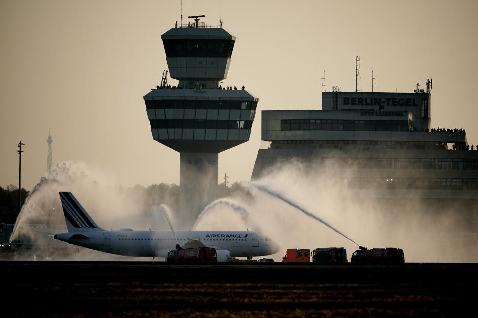 The airport fire brigade at Tegel Airport (TXL) sprayed water fountains on the Airbus of the French airline Air France as a farewell before its take-off for Paris in Berlin, Germany, Sunday, Nov. 8, 2020. Tegel Airport closes with the departure of the last scheduled flight number AF 1235 at 15:00. (Michael Kappeler/dpa via AP)
