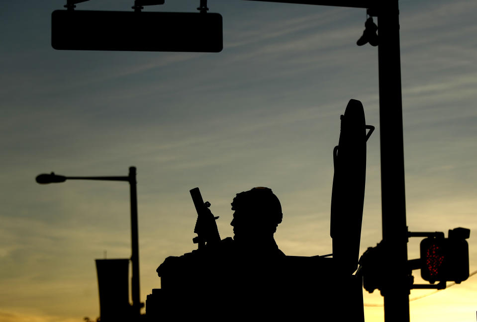 A Philadelphia Police Department SWAT team member sits in a vehicle in downtown Philadelphia during enforcement of a curfew, Monday, June 1, 2020. Philadelphia imposed a 6:00 p.m. to 6:00 a.m. curfew to prevent another night of destruction amid protests over George Floyd's death. (AP Photo/Matt Slocum)