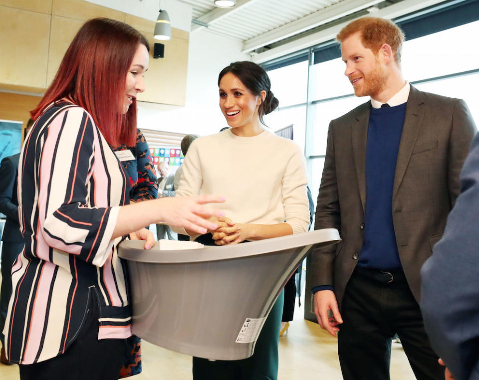 Prince Harry and Meghan Markle looking at a baby bath during a trip to Belfast in March (Picture: PA)