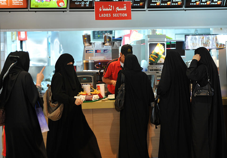 Saudi women wait in line in the "women section" at of a fast food resturant in the 'Faysalia' mall in Riyadh City, on September 26, 2011, a day after Saudi Arabia's King Abdullah bin Abdulaziz al-Saud granted women the right to vote and run in municipal elections, in a historic first for the ultra-conservative country where women are subjected to many restrictions.AFP PHOTO/FAYEZ NURELDINE (Photo credit should read FAYEZ NURELDINE/AFP via Getty Images)