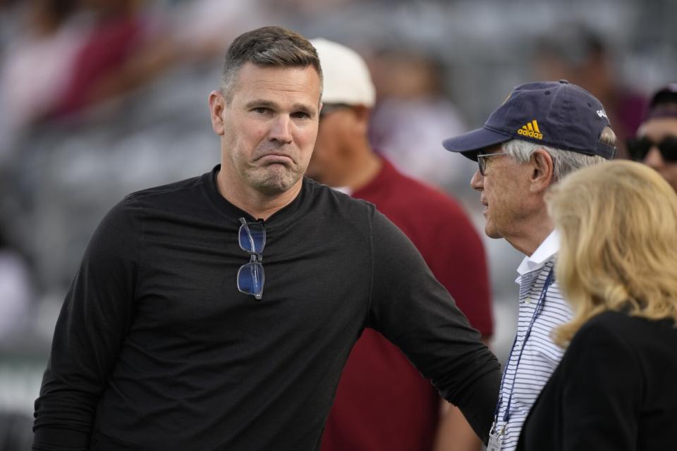 Galaxy coach Greg Vanney, left, chats with team owner Philip Anschutz and his wife, Nancy.