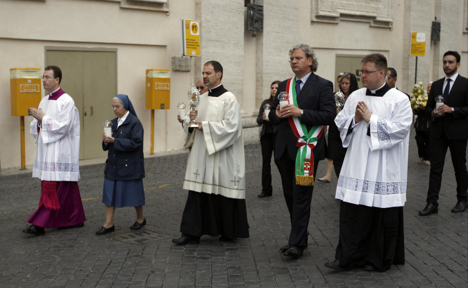 Don Ezio Bolis, Director of the John XXIII foundation and the Roncalli family, third from left, carries the relic of Pope John XXIII, in St. Peter's Square at the Vatican, Sunday, April 27, 2014. Pope Francis has declared his two predecessors John XXIII and John Paul II saints in an unprecedented canonization ceremony made even more historic by the presence of retired Pope Benedict XVI. (AP Photo/Andrew Medichini)