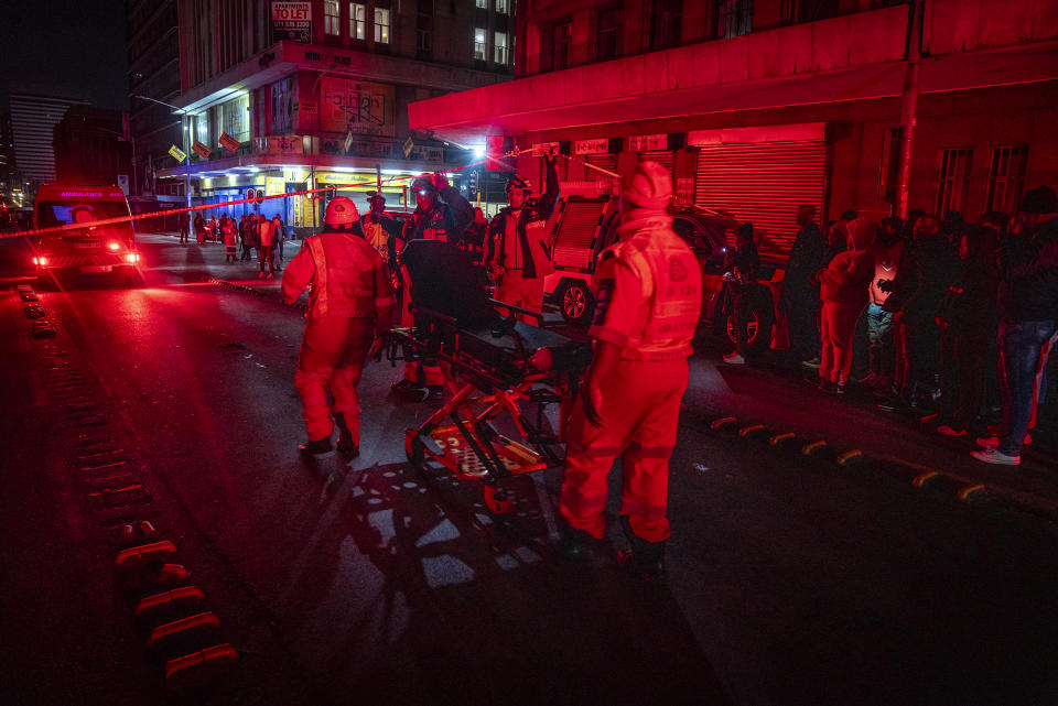 Emergency services gather at the scene of a gas explosion downtown Johannesburg, South Africa, Wednesday July 19, 2023. Search and rescue officials also ordered residents in nearby buildings to evacuate the area and the area where the explosion happened was cordoned off. (AP Photo/Shiraaz Mohamed)