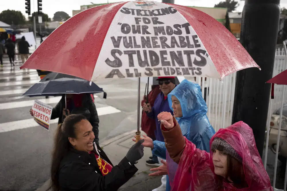 SEIU workers, teachers and supporters picket at Mclay Street and Foothill Blvd in San Fernando, Calif., Thursday, March 23, 2023, on the third day of a strike by SEIU and supported by UTLA for higher wages for Angeles Unified School District support staff. (David Crane/The Orange County Register via AP)