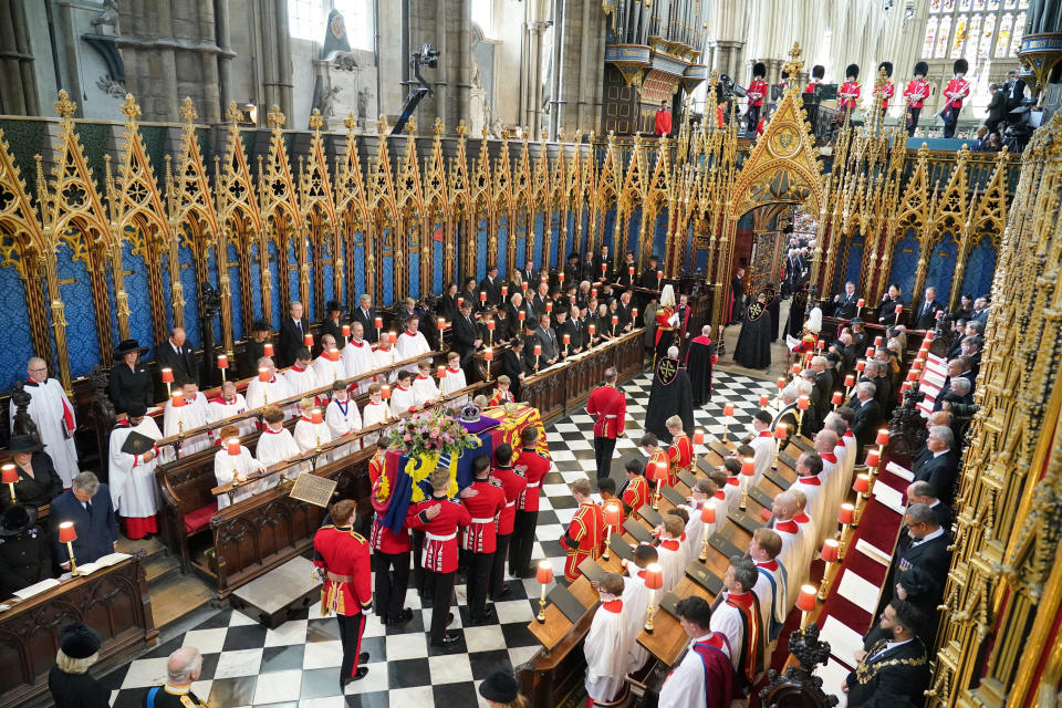 The coffin of Queen Elizabeth II, draped in the Royal Standard with the Imperial State Crown and the Sovereign's Orb and Sceptre, is carried from her State Funeral at Westminster Abbey in London. Picture date: Monday September 19, 2022.  Dominic Lipinski/Pool via REUTERS