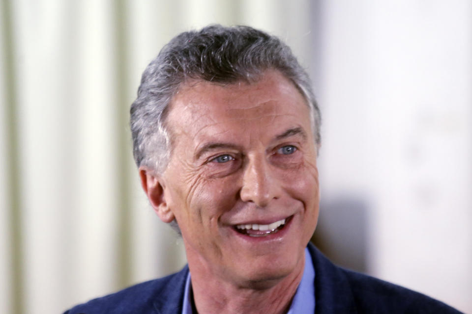 President Mauricio Macri speaks to journalists after voting in Buenos Aires, Argentina, Sunday, Oct. 27, 2019. Argentina could take a political turn in Sunday's presidential elections, with center-left Peronist candidate Alberto Fernandez favored to oust Macri amid growing frustration over the country's economic crisis.(AP Photo/Daniel Jayo)