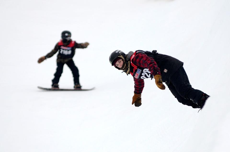 Snowboarders take part in a halfpipe competition at The Highlands.