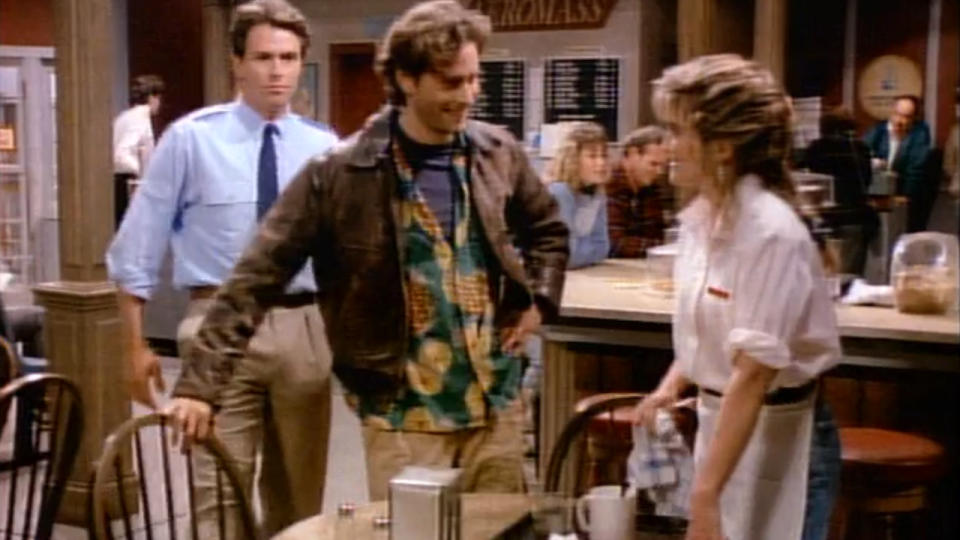 Tim Daly watches Steven Weber talking with Crystal Bernard in Wings.