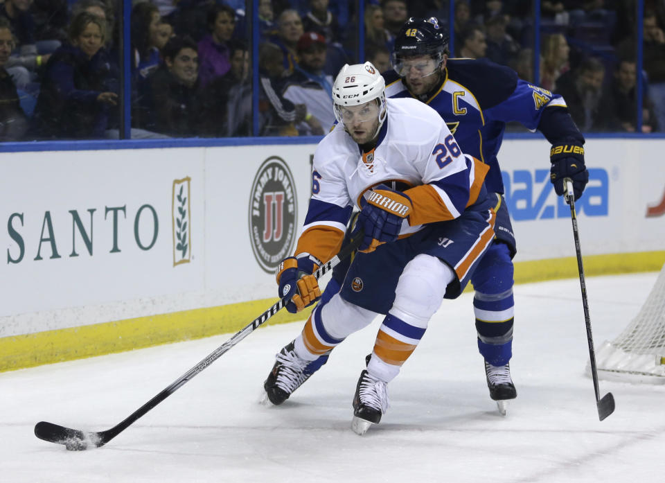 In this Dec. 5, 2013, photo, New York Islanders' Thomas Vanek, of Austria, looks to pass as St. Louis Blues' David Backes defends during an NHL hockey game in St. Louis. The Montreal Canadiens have acquired Vanek from the Islanders. Montreal sent forward prospect Sebastien Collberg, a 2014 second-round pick and a conditional fifth-rounder to the Islanders for Vanek on Wednesday, March 5, 2014. (AP Photo/Jeff Roberson)