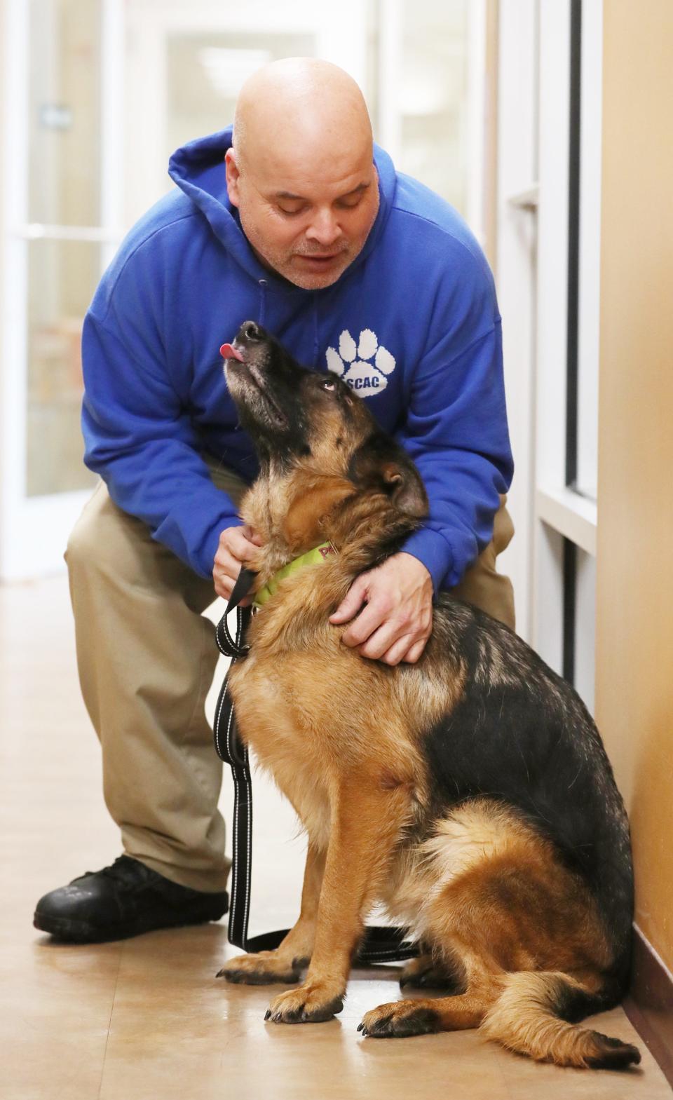 J.J. Bahr, a pound keeper, talks to Paczki, a 5-year-old purebred German shepherd at Summit County Animal Control on Jan. 26 in Akron.