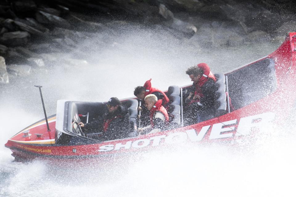 Biebs boards a boat and looks, well bored...