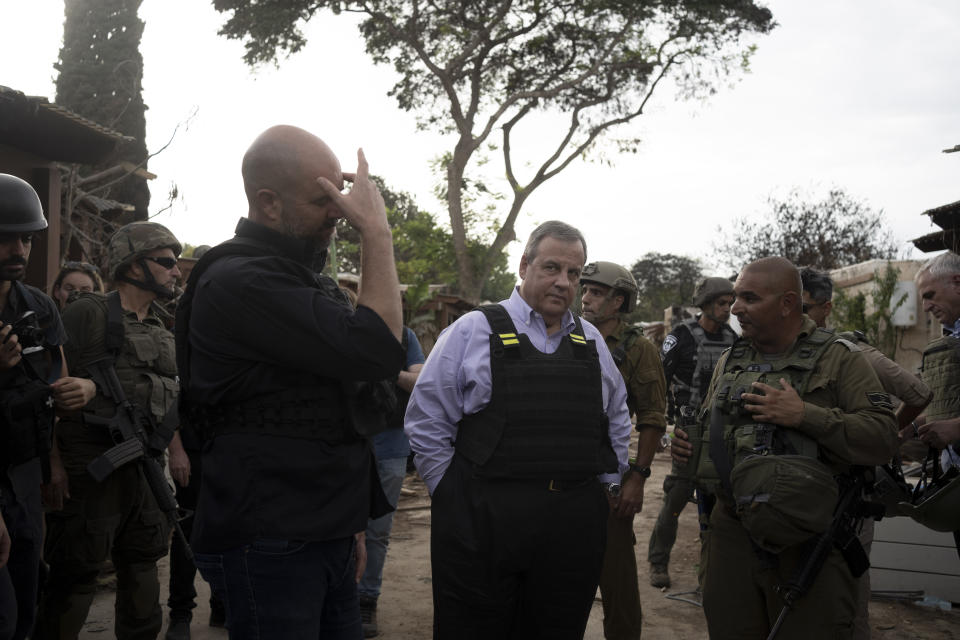 Former New Jersey Governor Chris Christie, center, visits Kibbutz Kfar Azza, near the Israel-Gaza Border, the site of an Oct. 7 massacre by Hamas, with Israel's Knesset Speaker Amir Ohana, left, Sunday, Nov. 12, 2023. (AP Photo/Maya Alleruzzo)