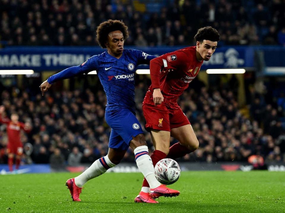 Willian (left) battles for the ball with Liverpool's Curtis Jones: Getty