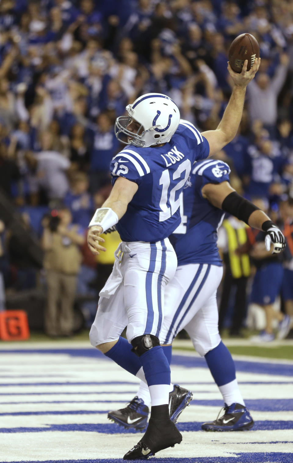 Indianapolis Colts quarterback Andrew Luck (12) celebrates after scoring a touchdown against the Kansas City Chiefs during the second half of an NFL wild-card playoff football game Saturday, Jan. 4, 2014, in Indianapolis. (AP Photo/Michael Conroy)