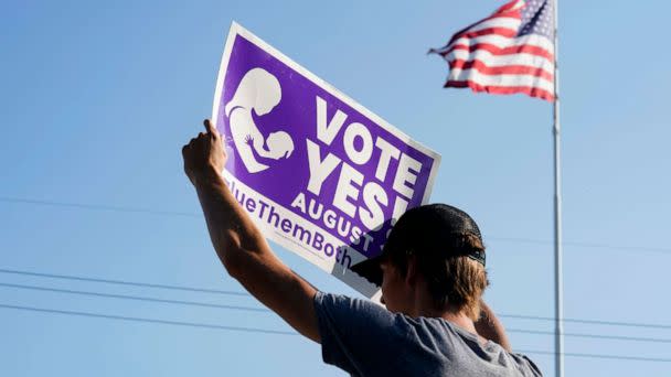 PHOTO: A supporter of the Vote Yes to a Constitutional Amendment on Abortion holds up a sign in Olathe, Kansas, Aug. 01, 2022.  (Kyle Rivas/Getty Images)