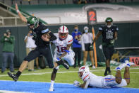 Tulane quarterback Michael Pratt (7) scores a touchdown against SMU safety Chace Cromartie (18) in the second half during an NCAA college football game in New Orleans, Friday, Oct. 16, 2020. (AP Photo/Matthew Hinton)