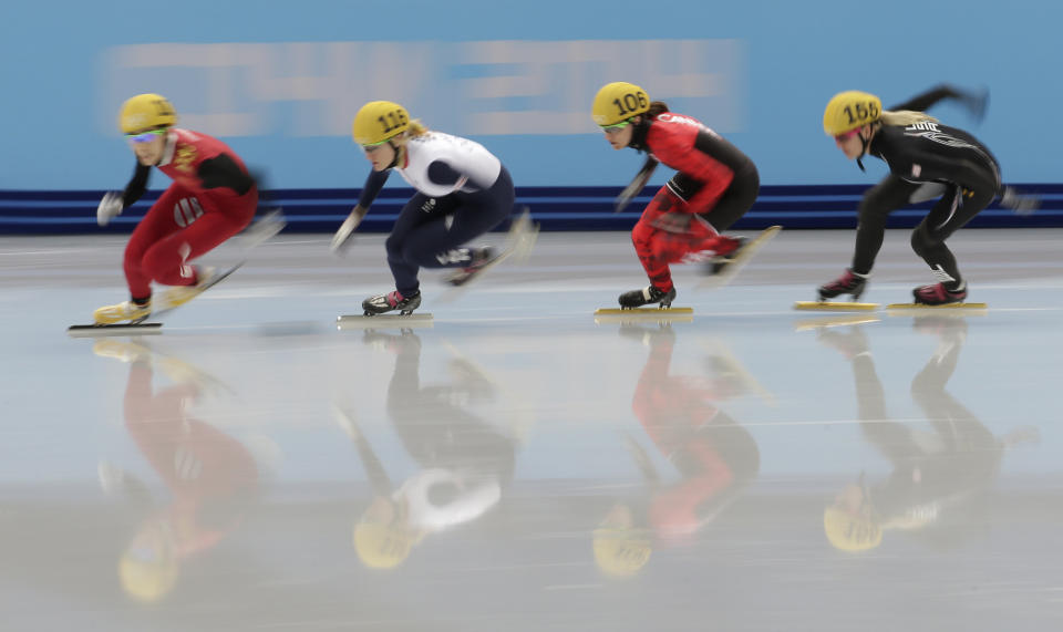 Fan Kexin of China, Elise Christie of Britain, Jessica Hewitt of Canada and Emily Scott of the United States compete in a women's 500m short track speedskating quarterfinal at the Iceberg Skating Palace during the 2014 Winter Olympics, Thursday, Feb. 13, 2014, in Sochi, Russia. 