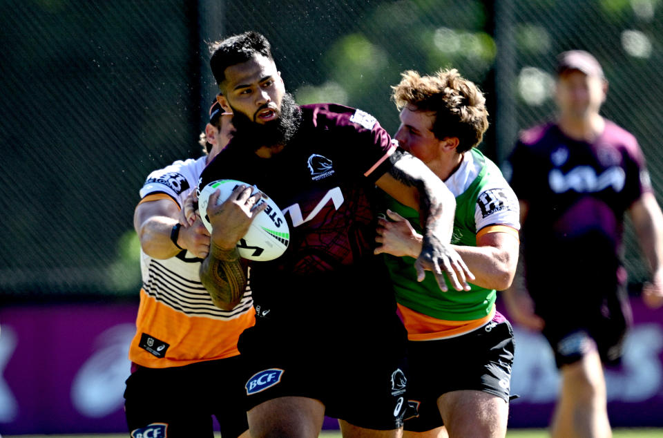 BRISBANE, AUSTRALIA - APRIL 30: Payne Haas takes on the defence during a Brisbane Broncos NRL training session at Clive Berghofer Field on April 30, 2024 in Brisbane, Australia. (Photo by Bradley Kanaris/Getty Images)