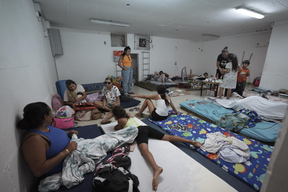 Israelis rest in a bomb shelter following rocket attacks fired from the Gaza Strip towards Israel, in Ashkelon, southern Israel, Sunday, Aug. 7, 2022. Israel has killed two senior Islamic Jihad militants in three days of air strikes in the Gaza Strip, and Palestinian militants have launched nearly 600 rockets at Israel. Palestinian officials say at least 31 people in Gaza have died. (AP Photo/Tsafrir Abayov)