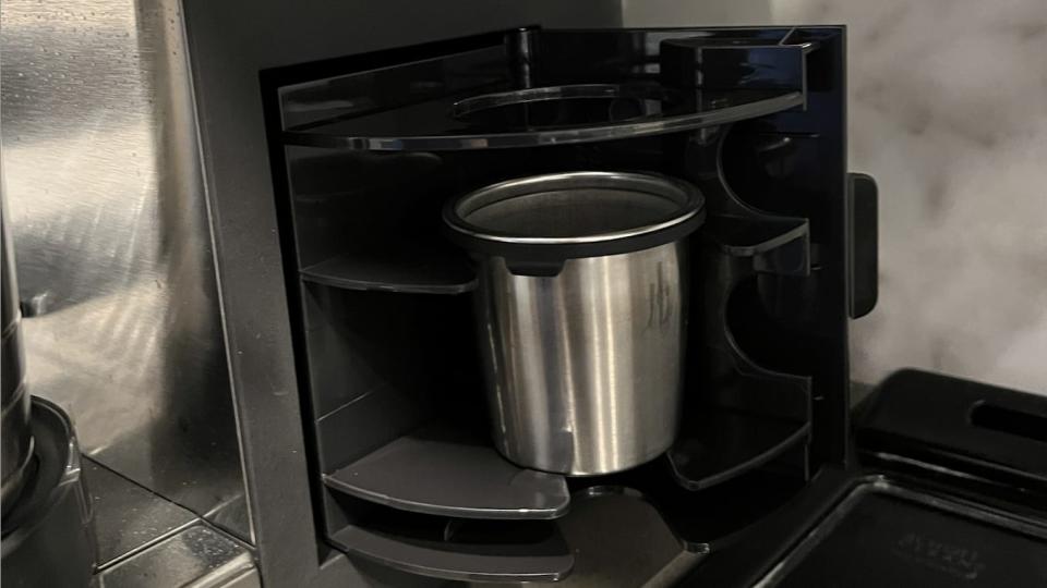 An inside view of the coffee maker's internal storage cabinet. 