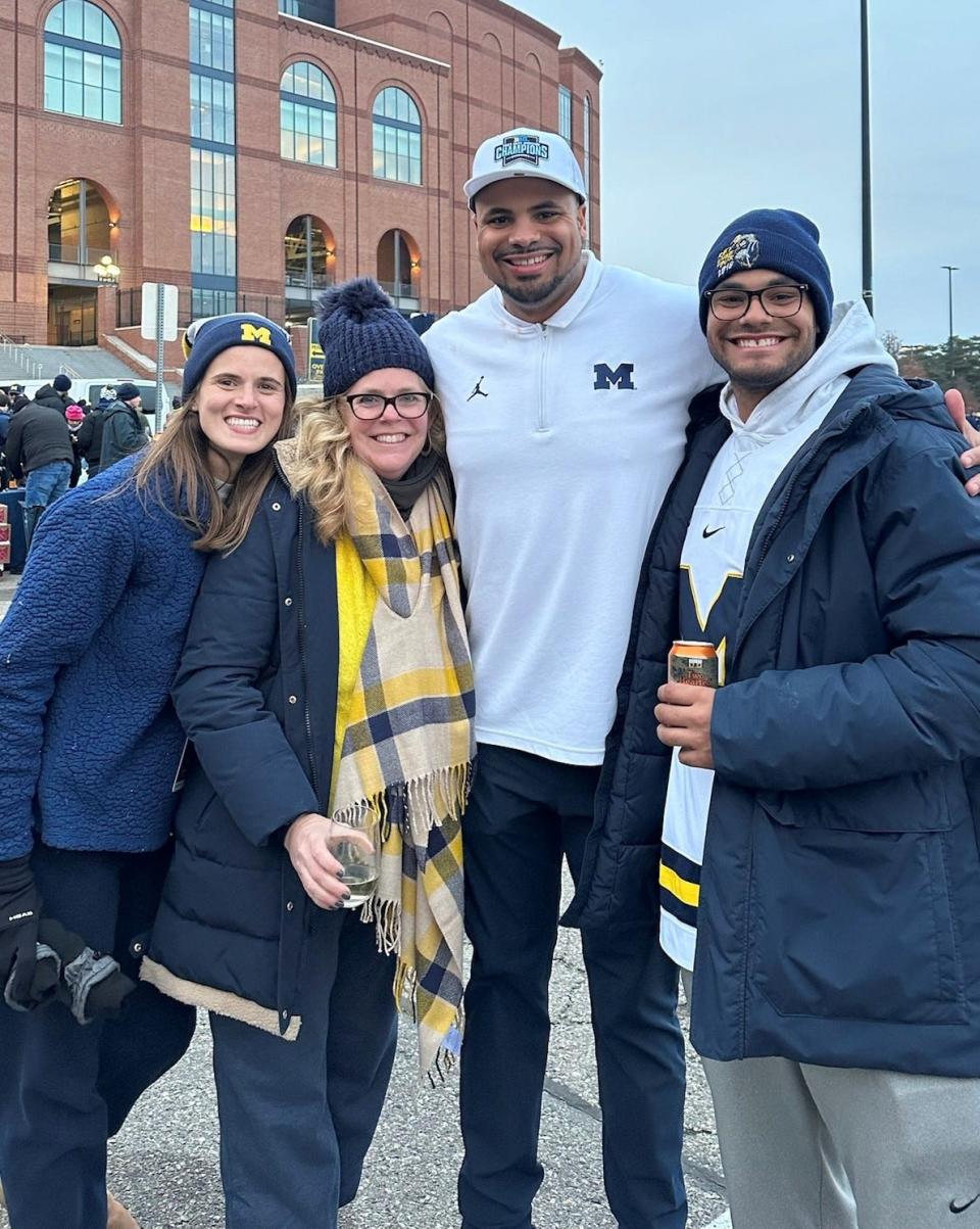 Kim Newsome (second from left) visits a Michigan football game last season to see her son Grant (second from right), who is an assistant coach for the team. Grant’s wife, Caroline, is on her left and brother Garrett is on the far right.