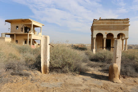 An abandoned Romanian church (R) and building belonging to it, are seen in an area surrounded by land mines and explosives near Qasr Al-Yahud, Jesus's traditional baptismal site along the Jordan River, near Jericho in the West Bank January 16, 2017. Picture taken January 16, 2017. REUTERS/Ori Lewis