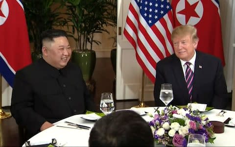 Donald Trump and Kim Jong-un at dinner at the Metropole Hotel in Hanoi - Credit: Broadcast via AP