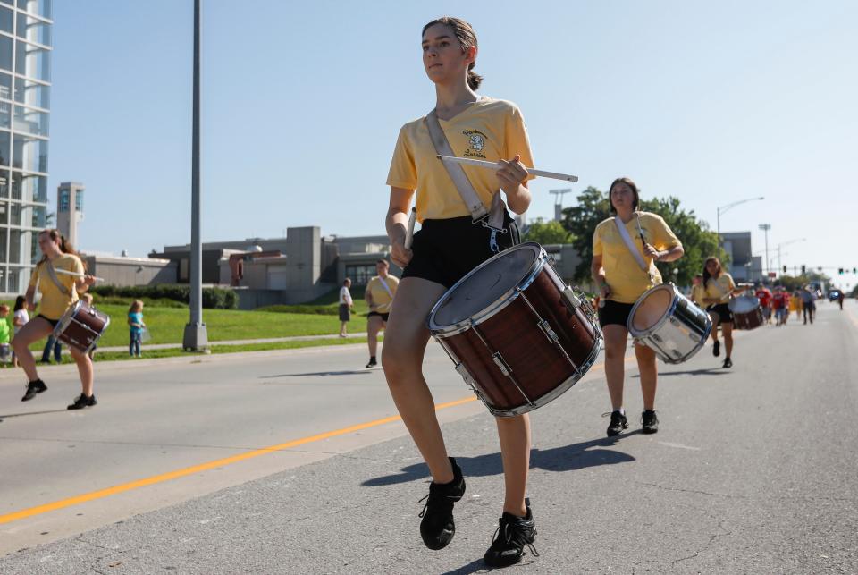 A member of the Parkview High School Lassies drums and marches during the Labor Day Parade on Monday, Sep. 2, 2019, in Springfield, Mo.