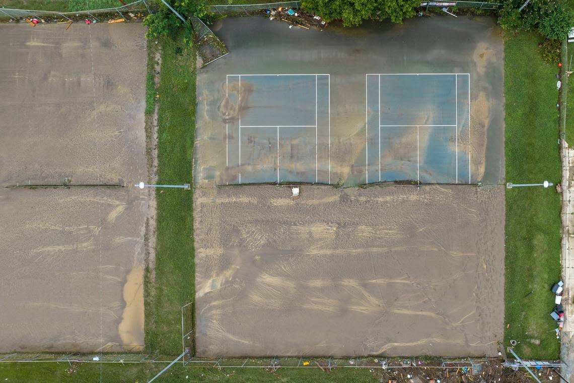 Mud covers tennis courts near Whitesburg Middle School in Whitesburg, Ky., on Friday, July 29, 2022.