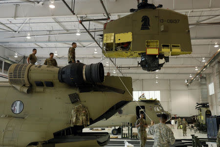 Soldiers from the 1st Armored Division, Combat Aviation Brigade, work to disassemble a CH-47 Chinook helicopter to ship to Puerto Rico in order to aid in recovery efforts following Hurricane Maria at Fort Bliss in El Paso, Texas, U.S., September 29, 2017. Picture taken September 29, 2017. REUTERS/Lucas Jackson