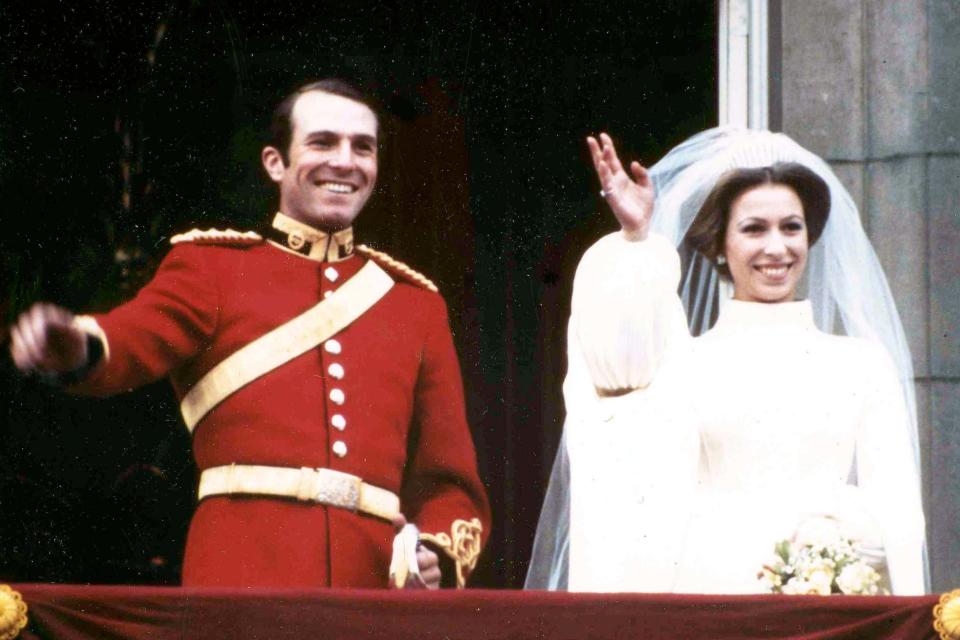 Princess Anne and her husband Captain Mark Phillips wave from the balcony of Buckingham Palace (AP)