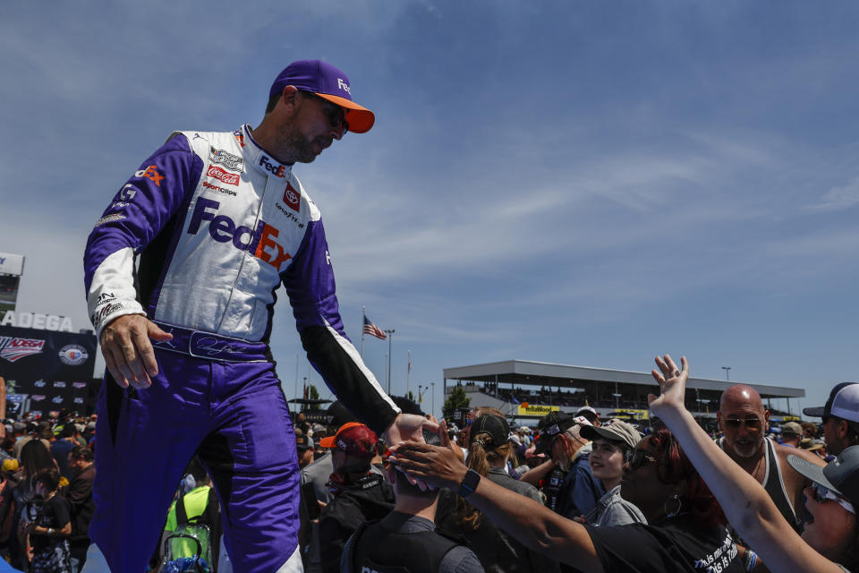 Denny Hamlin greets fans as he is introduced before a NASCAR Cup Series auto race at Talladega Superspeedway, Sunday, April 23, 2023, in Talladega, Ala. (AP Photo/Butch Dill)