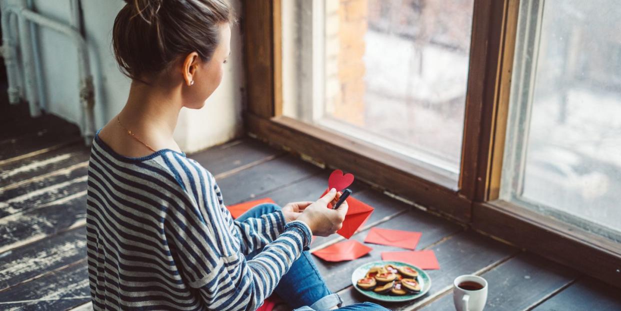 young woman writing a valentine card