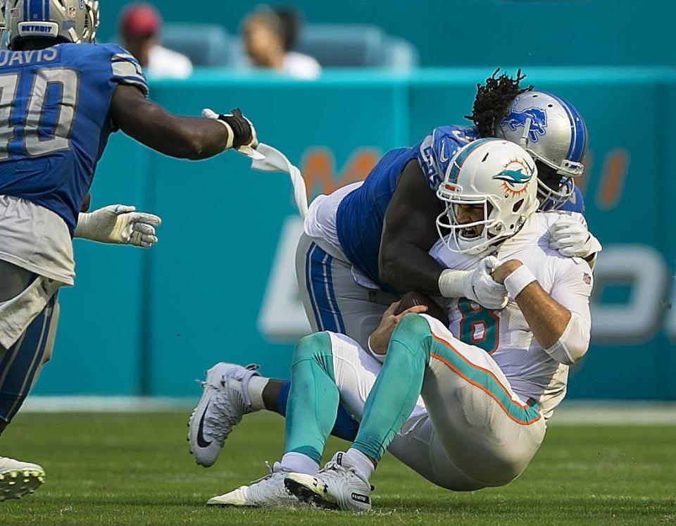 Former Miami Dolphins quarterback Brock Osweiler is sacked by Detroit Lions defensive tackle Ricky Jean Francois [BILL INGRAM/palmbeachpost.com]