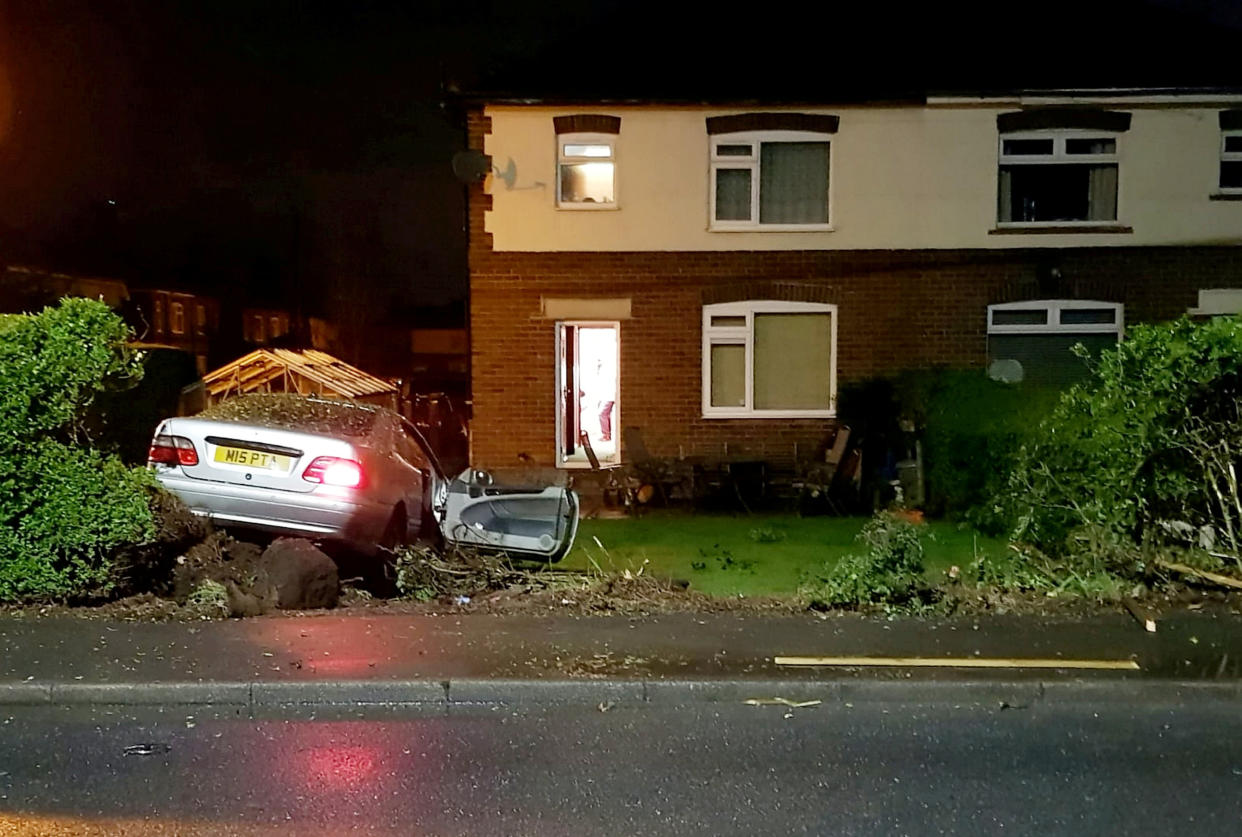 A fuming grandfather is too scared to sit in his garden after a string of cars crashed into his property.  See SWNS story SWMDcrashes.  Scott Thomas, 54, says he is fed-up of replacing his fence and replanting trees after they have been destroyed on three occasions since 2019.  The grandfather-of-seven is now demanding the council reduce the speed limit outside his home in Dobshill, North Wales, to stop more drivers demolishing his garden.  The fork-lift truck driver says the crashes have caused more than £10,000 worth of damage to his property.  Scott is now demanding the speed limit is halved from 40mph to 20mph on the A549 road, called Dirty Mile, which runs by his home.  The dad-of-three said: 