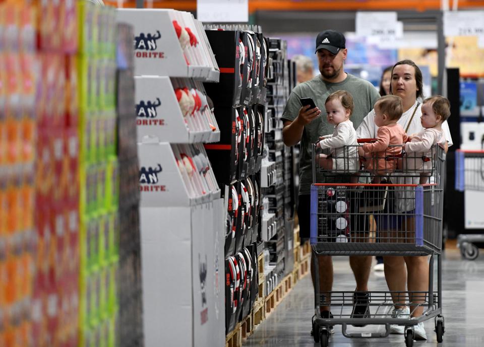 Andrew and Melissa Stevelton of Jackson Township, with their triplet daughters, visit Costco Wholesale in Jackson Township.