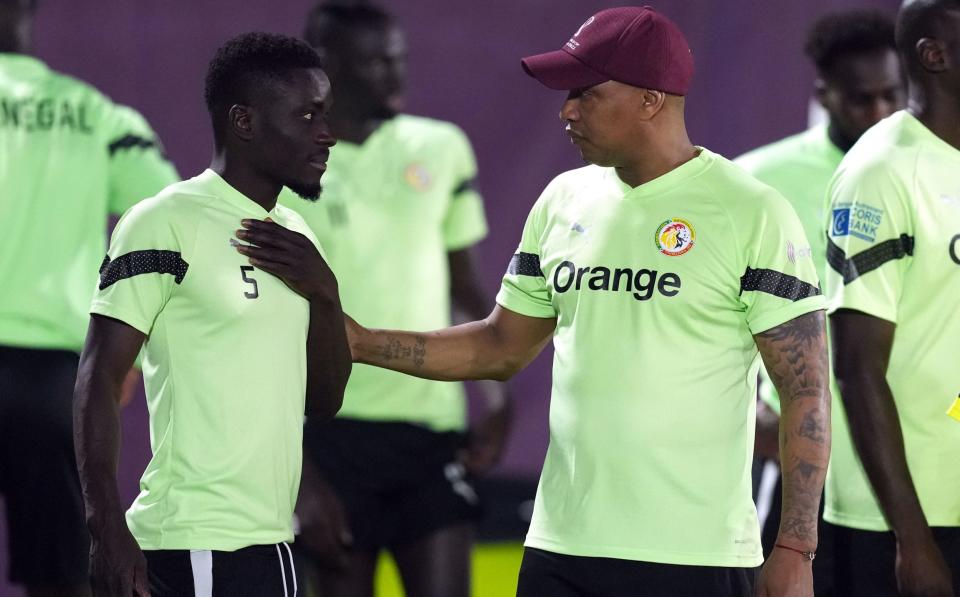 Diouf talks to Idrissa Gueye in training before Senegal's clash with England - Martin Rickett/PA