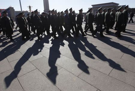 Military delegates walk towards the Great Hall of the People for a plenary meeting of the National People's Congress (NPC), China's parliament, in Beijing in this March 4, 2013 file photo. REUTERS/Jason Lee/Files