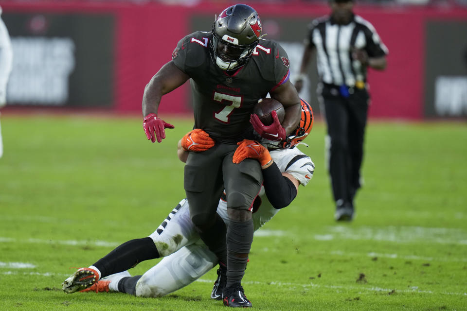 Tampa Bay Buccaneers running back Leonard Fournette (7) is stopped by Cincinnati Bengals linebacker Logan Wilson (55) during the first half of an NFL football game, Sunday, Dec. 18, 2022, in Tampa, Fla. (AP Photo/Chris O'Meara)