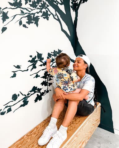 <p>Christina Milian Instagram</p> Christina Milian holding her son Kenna Pokora.