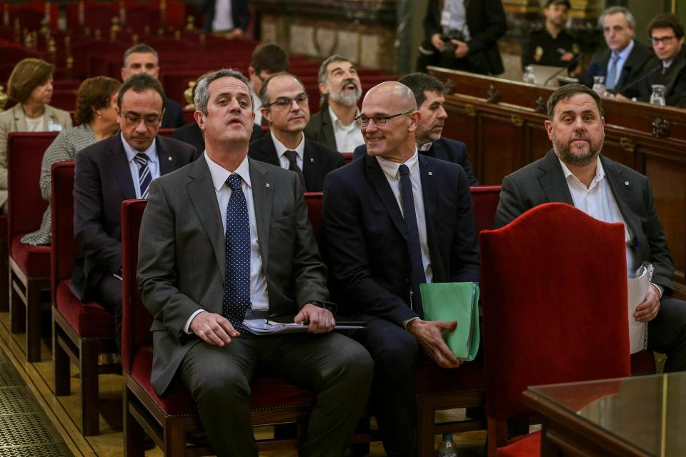 Front row from left, Joaquim Form, Raul Romeva, Oriol Junquera, second row from left, Josep Rull, Jordi Turull, Jordi Sanchez, third row from left, Dolors Bassa, Carmen Forcadell, Jordi Cuixart, back row from left, Meritxell Borras, Santiago Vila, and Carles Mundo during the trial at the Spanish Supreme Court in Madrid, Tuesday, Feb. 12, 2019. Spain is bracing for the nation's most sensitive trial in four decades of democracy this week, with a dozen Catalan separatists facing charges including rebellion over a failed secession bid in 2017. (Emilio Naranjo/Pool via AP)